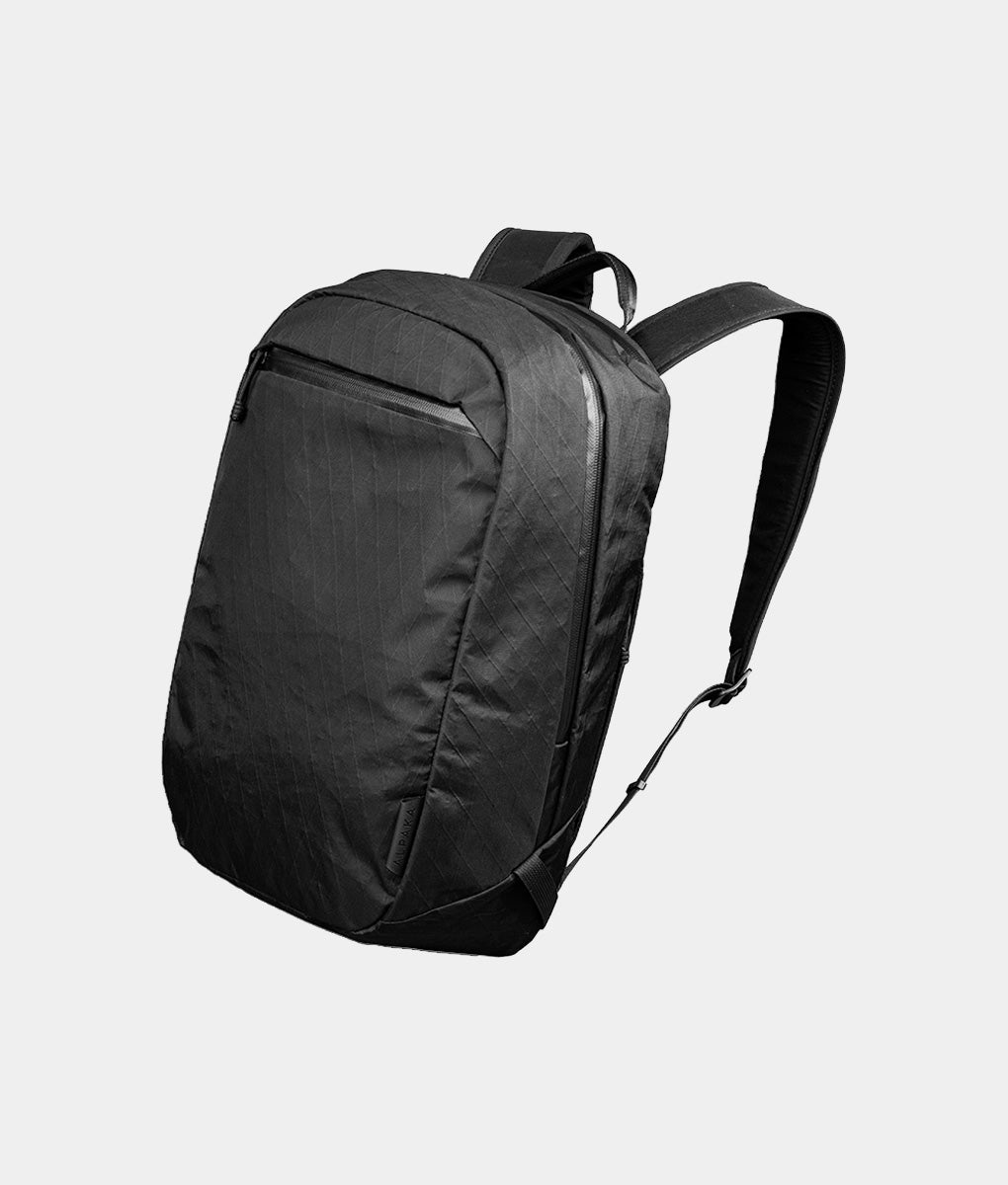 areo travel backpack Pakt Cero Lightweight 35L through slides over a rolling suitcase Aero 60L Vacuum-Seal Air Compression